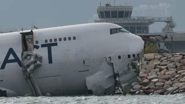 Cargo plane skids off Hong Kong airport runway into sea, leaving two dead